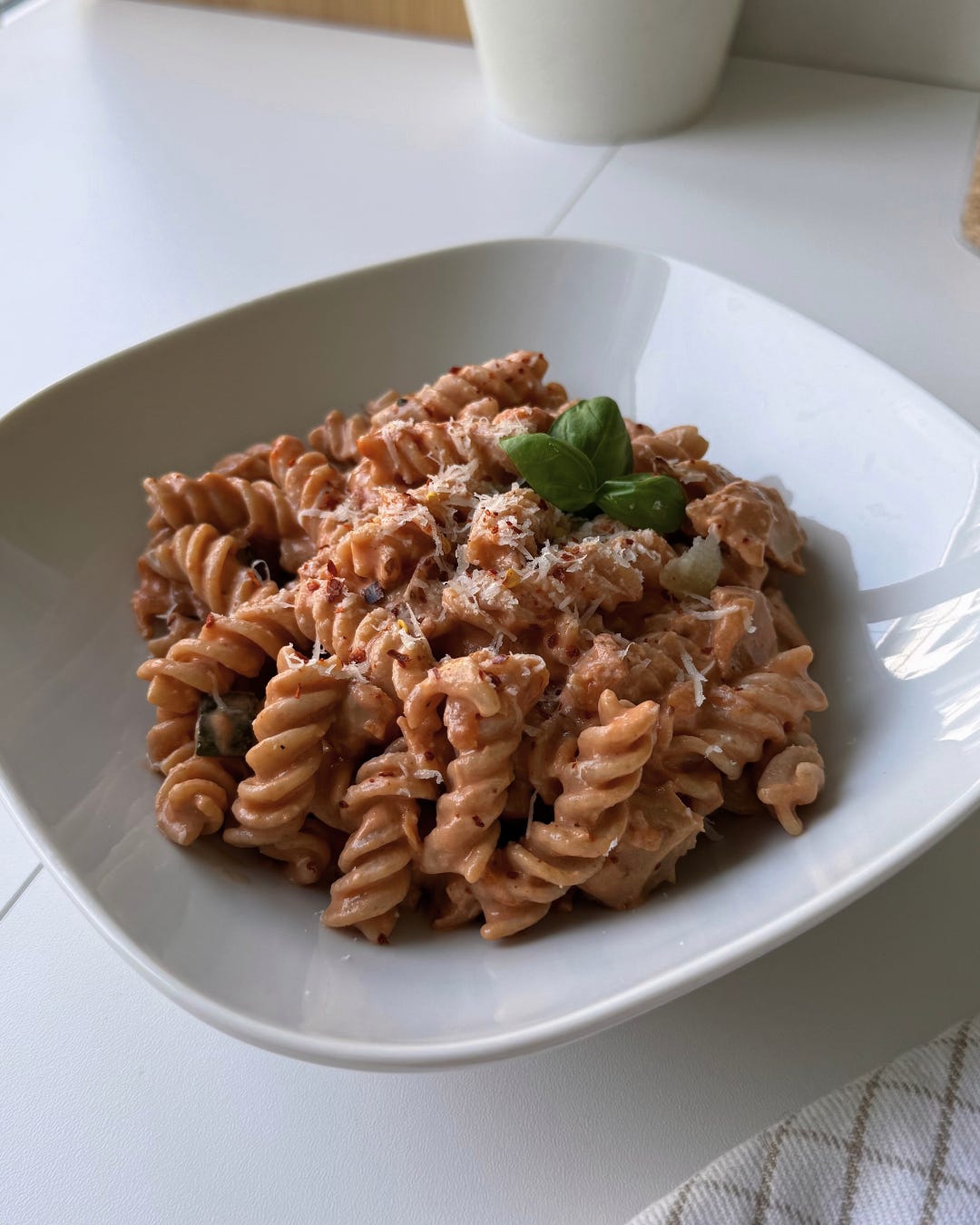 Healthy Skyr pasta with plant-based chicken and vegetables served on a white plate