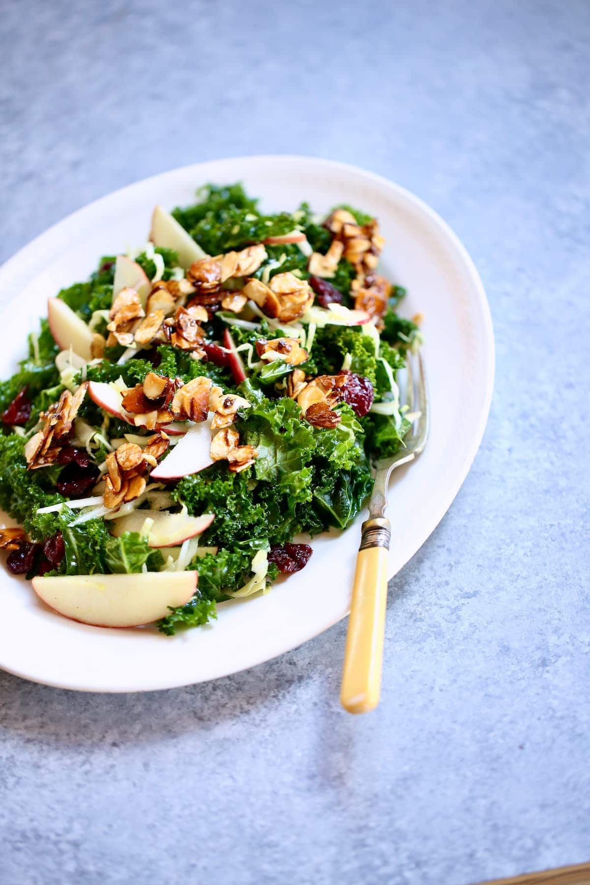 a white plate with a salad on it.