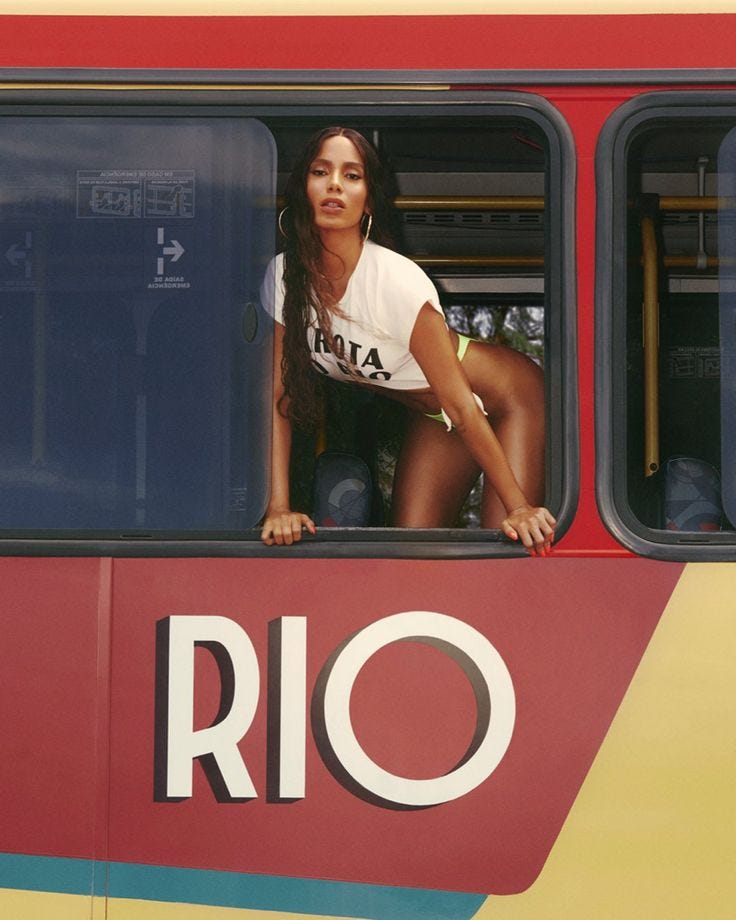 This may contain: a woman leaning out the window of a bus with her hands on the windowsill