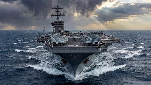 Large naval aircraft carrier moves through ocean waters under cloudy sky with jets lined up on deck Large naval aircraft carrier moves through ocean waters under cloudy sky with jets lined up on deck