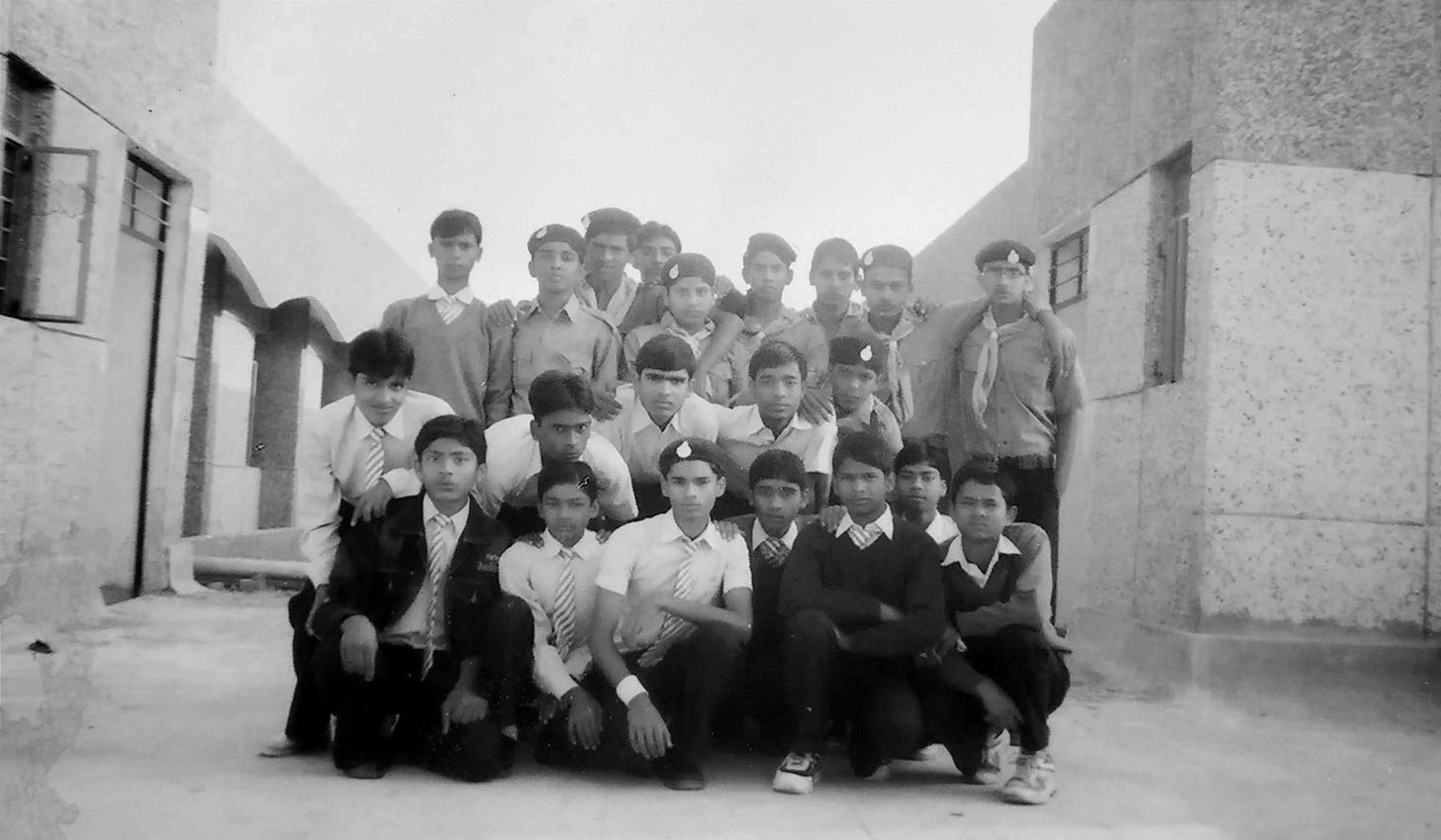 A black-and-white group photograph of schoolboys in uniform gathered on terrace of boys' hostel of a Jawahar Navodaya Vidyalaya, from YayavarAbhi school days A black-and-white group photograph of schoolboys in uniform gathered on terrace of boys' hostel of a Jawahar Navodaya Vidyalaya, from YayavarAbhi school days