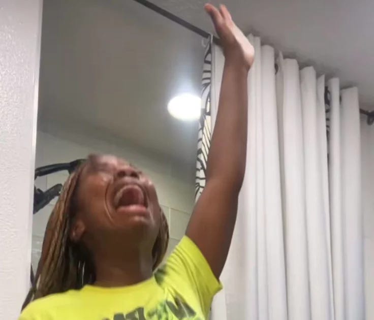 This may contain: a woman in yellow shirt holding her arms up with both hands and mouth wide open This may contain: a woman in yellow shirt holding her arms up with both hands and mouth wide open