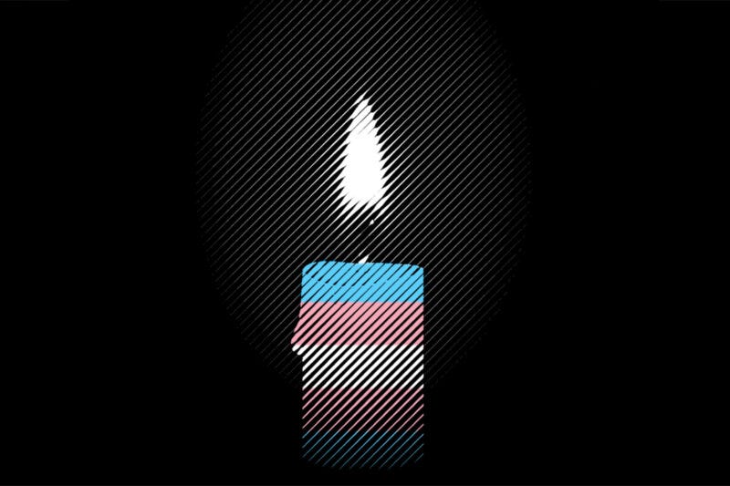Candle with a flame glowing in the darkness, wrapped in the colors of the transgender pride flag—blue, pink, and white—symbolizing remembrance, mourning, and solidarity for Transgender Day of Remembrance.