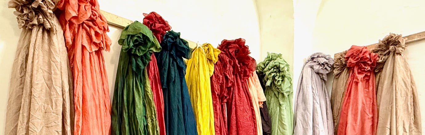 Several colorful scarves on a wall

AI-generated content may be incorrect.