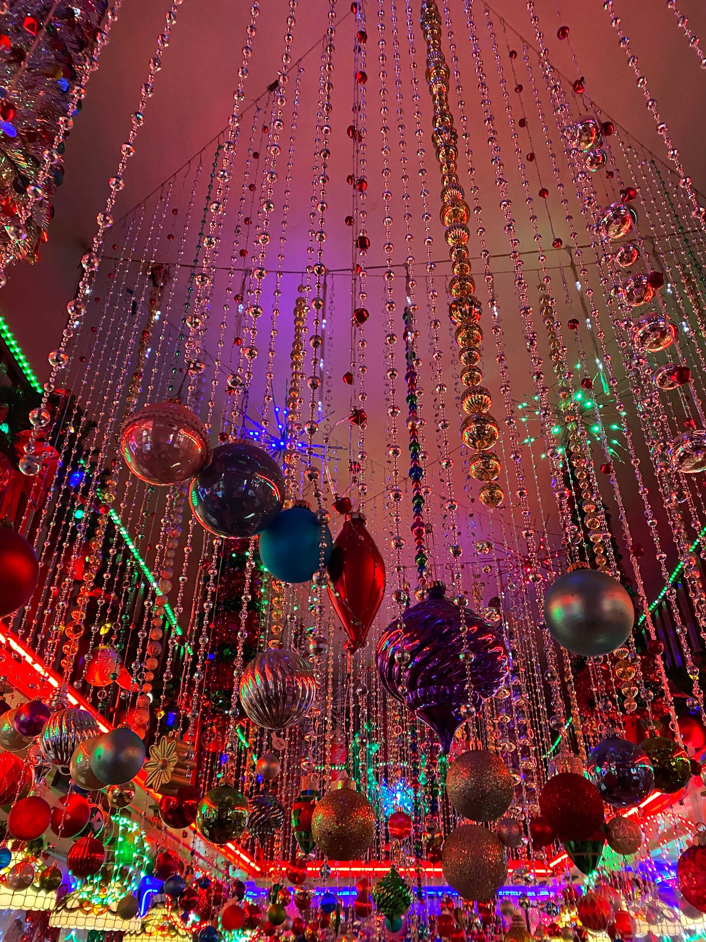 Hanging Christmas ornaments and decorations at Orphan Andy's in San Francisco