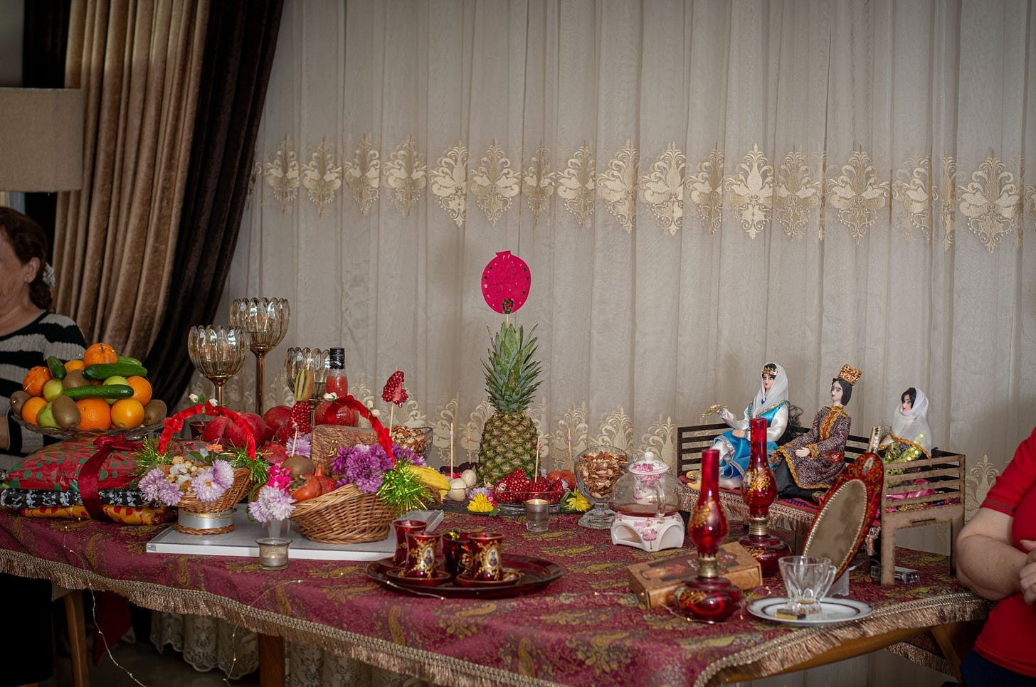 A Yalda Night table is prepared with gifts and fruits including pomegranate, watermelon, cakes and pastries, in line with a book by Hafez. (Shutterstock)