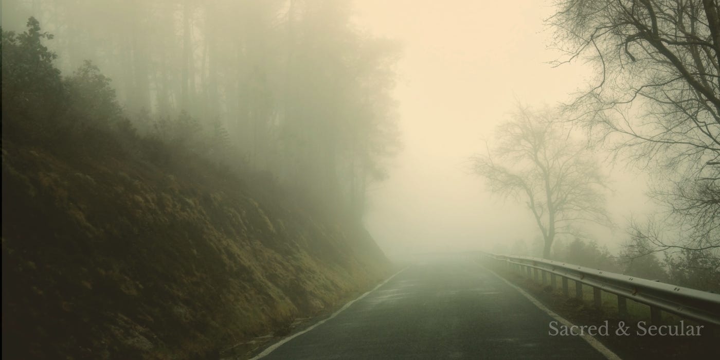 A quiet path or road fading into soft morning light, with mist obscuring the distance ahead