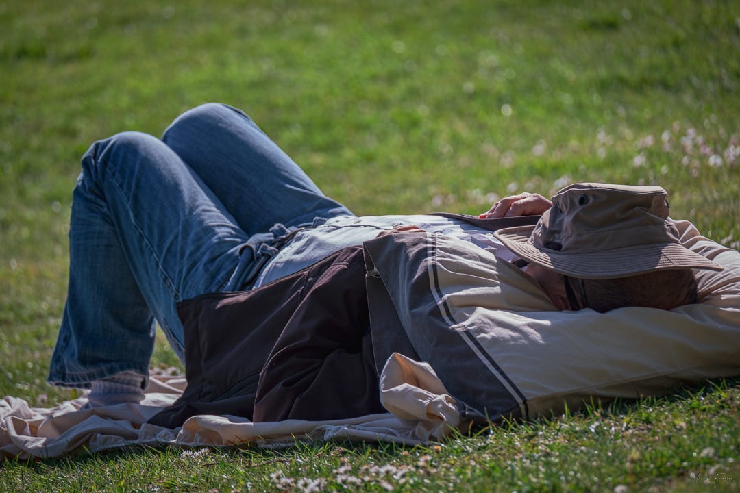A man napping in a park A man napping in a park