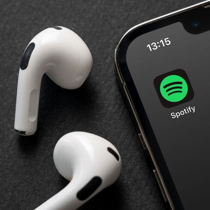 This may contain: an iphone and earphones sitting next to each other on top of a black surface