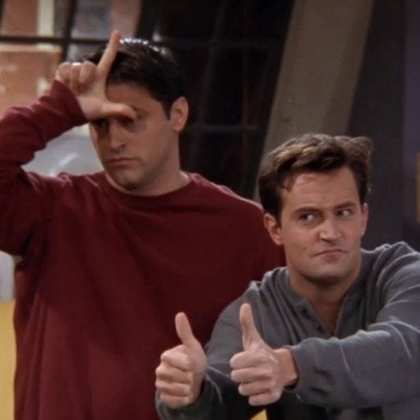 This may contain: two men giving the thumbs up sign