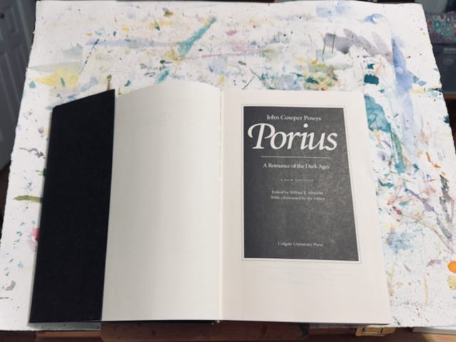 Open book on a wooden bookstand showing the title page of Porius