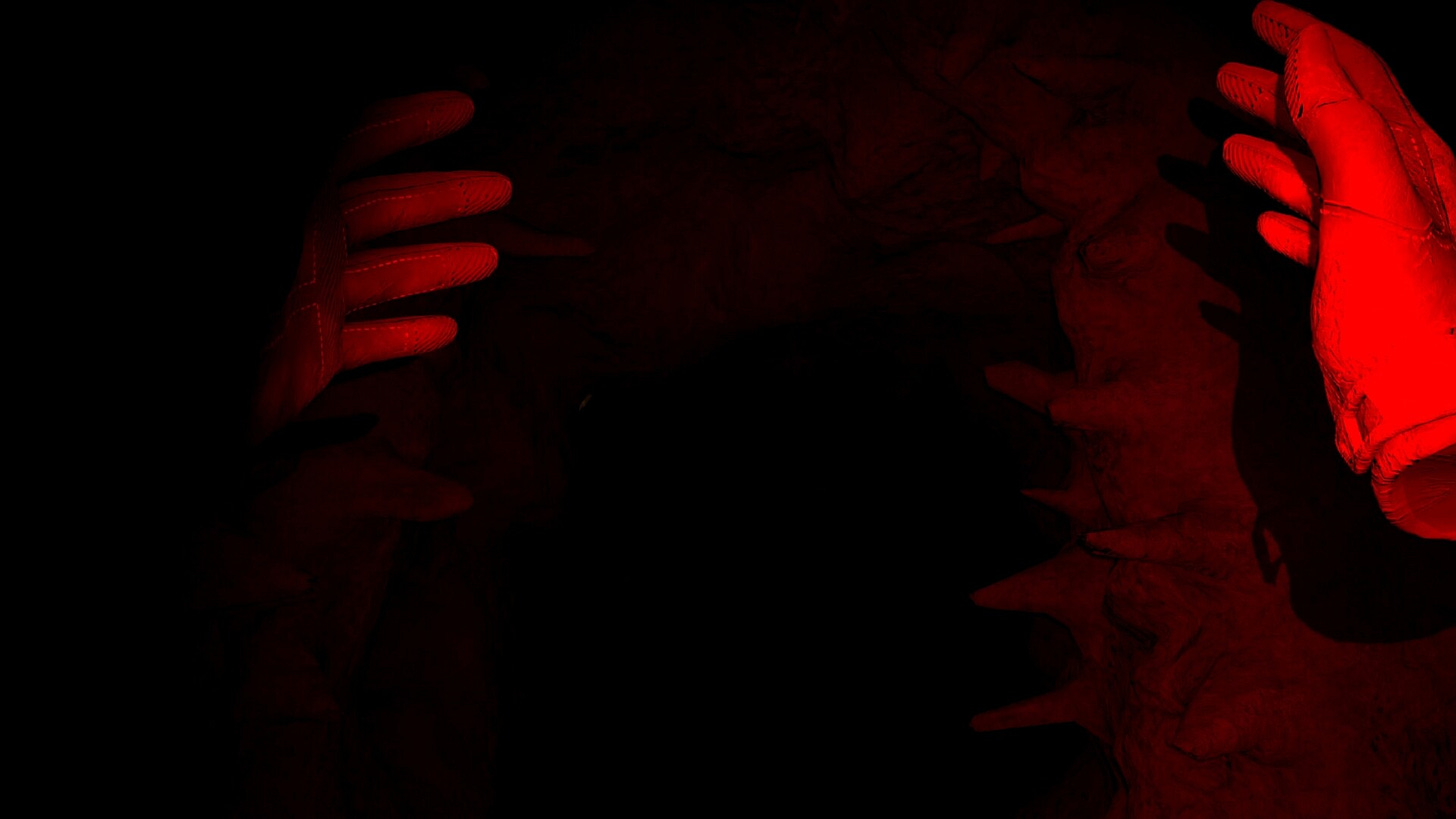 Hands float in red light pulsing through a dark cave
