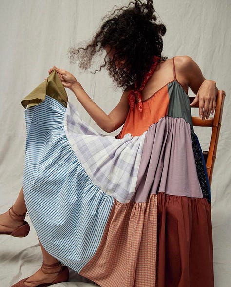 An assortment of textile art and patchwork dresses made by Sarah Nsikak.