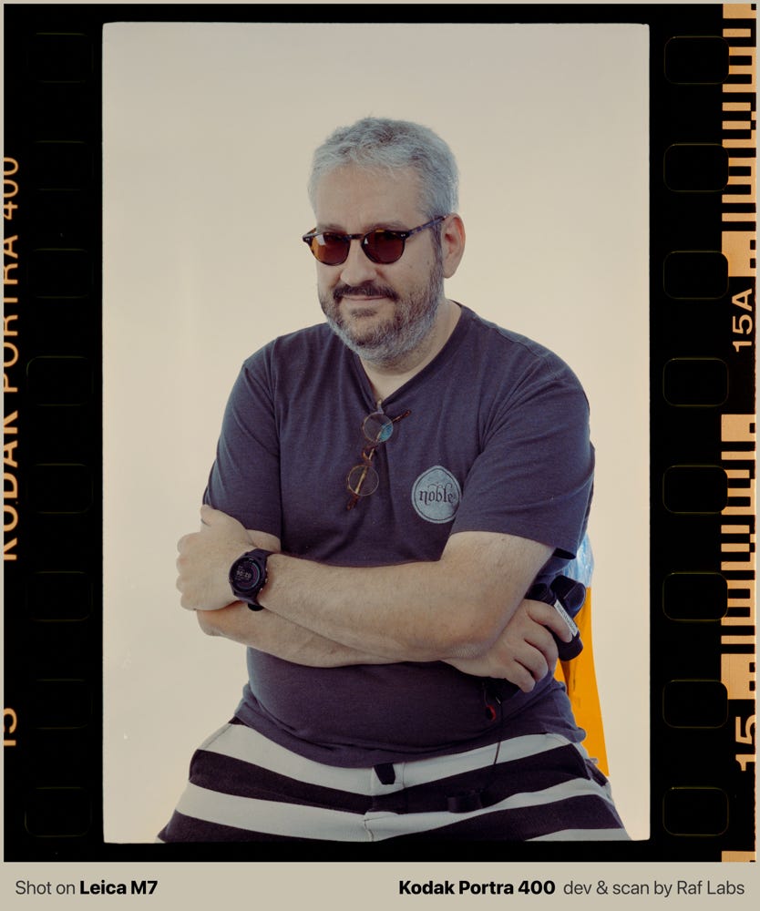 Photo of Raf holding the light meter with an orange background. Photo of Raf holding the light meter with an orange background.