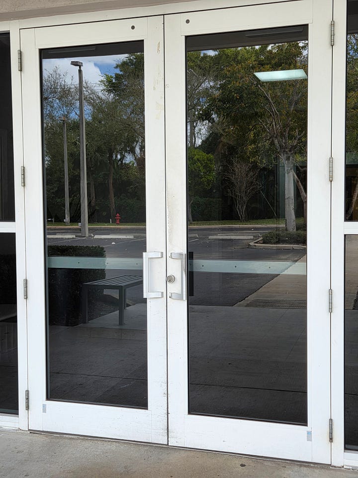 Clockwise from top left: A set of automatic, sliding doors; a set of heavy glass doors with a vertical handle the height of the door; an image of a square button with a wheelchair symbol on it that says “Press to Open”; and a set of heavy glass doors and a steel frame (painted white), with small metal handles on each.