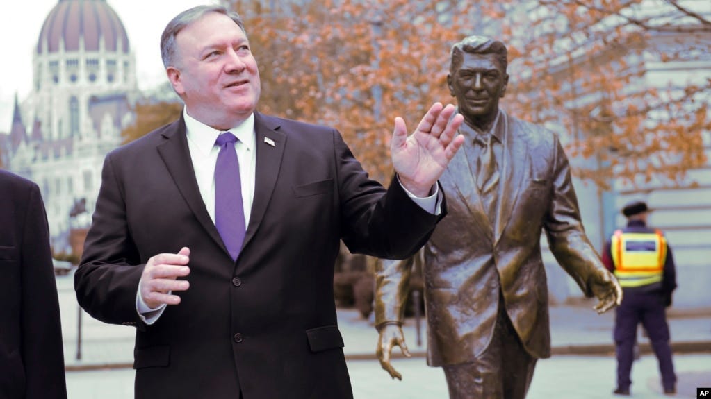 US Secretary of State, Mike Pompeo, is pictured next to a scuplture of former US President Ronald Reagan at the Liberty square (Szabadsag) in Budapest, Hungary, Feb. 11, 2019. 