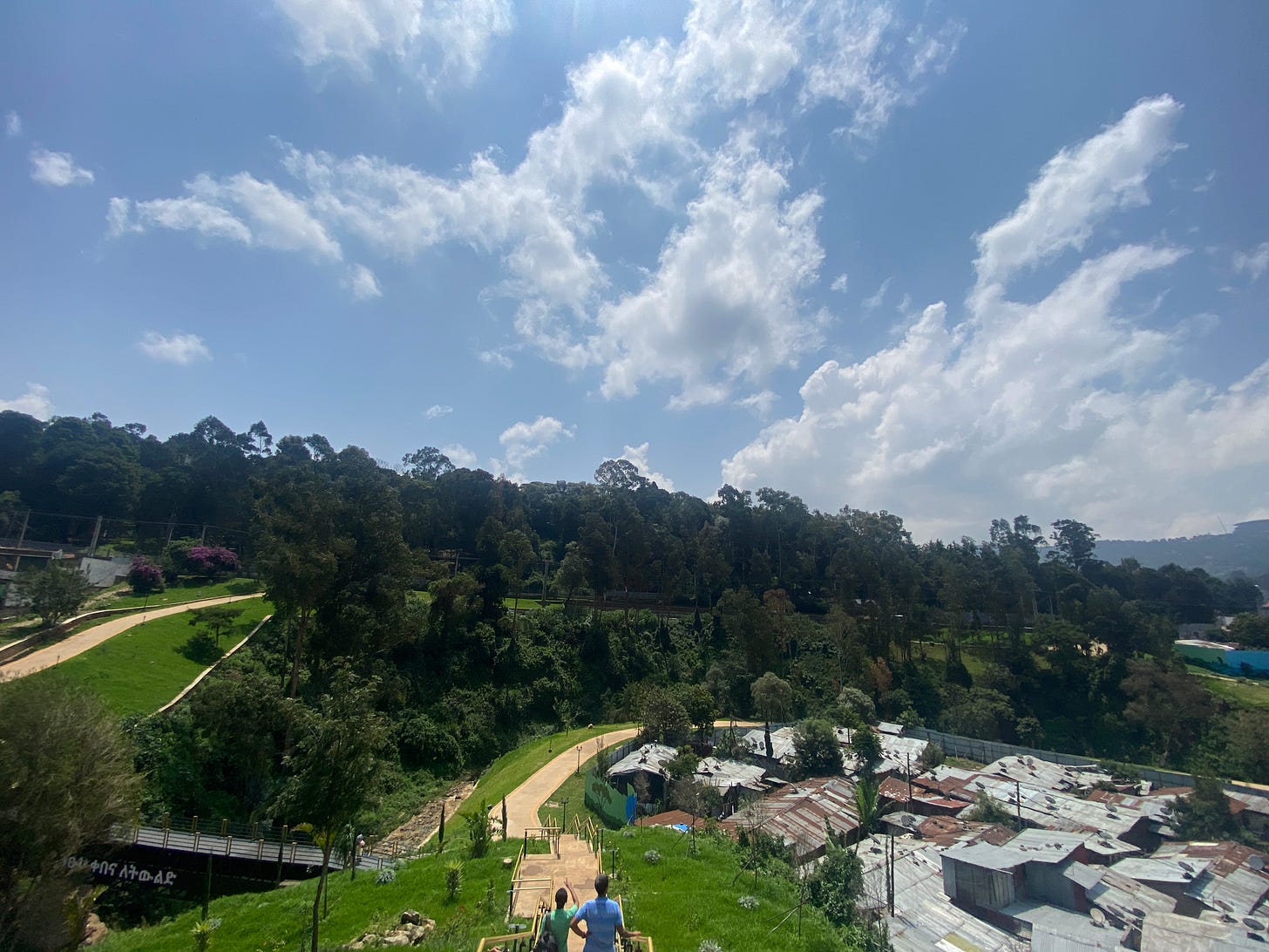 Two people looking across the two sides of Kebena Riverside Park in Addis Ababa, Ethiopia.