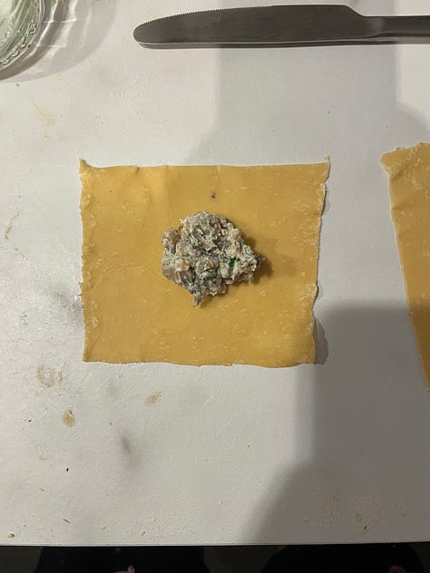 Steps for making tortellini from fresh using a pasta machine illustrated. The pasta is rolled before cut into squares, with a small amount of filling added and then folded into a triangle before the bottom two corners are tied around