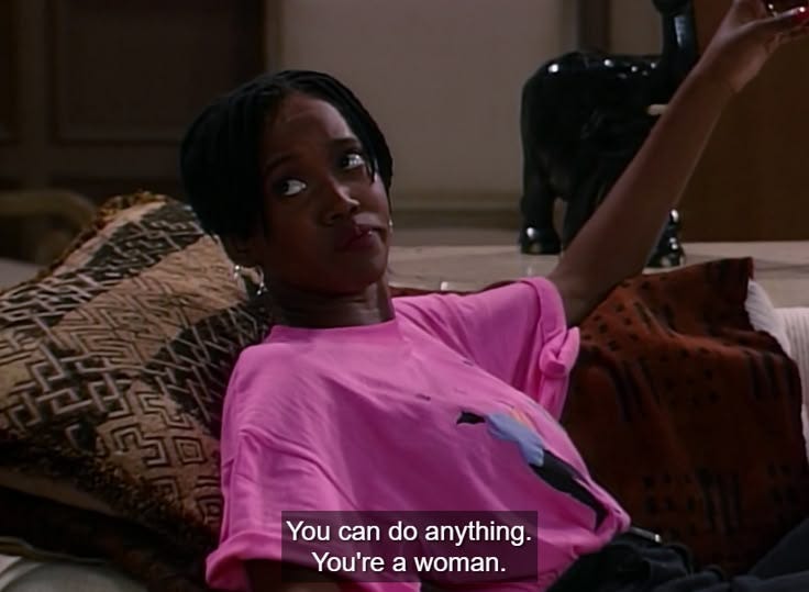 This may contain: a woman sitting on top of a couch holding a wine glass in her hand with the caption you can do anything, you're a woman