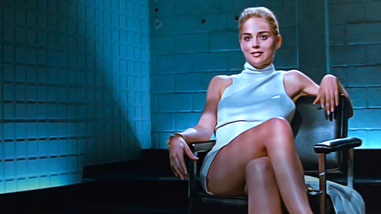 famous basic instinct scene; sharon stone in white dress in interrogation room, smiling, legs crossed