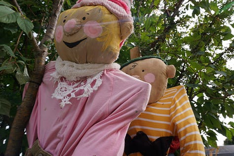 Scarecrows wear old clothing, colourful accessories, and funny expressions on their faces as they stand propped up against lampposts and other landmarks in Charlottetown.