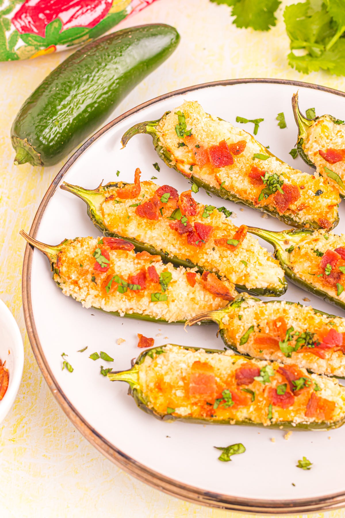 Jalapeno poppers on plate on table.
Jalapeno poppers on plate on table.