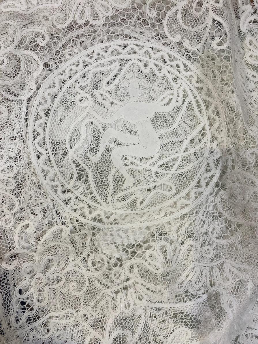 A white lace with a person in the center
AI-generated content may be incorrect.