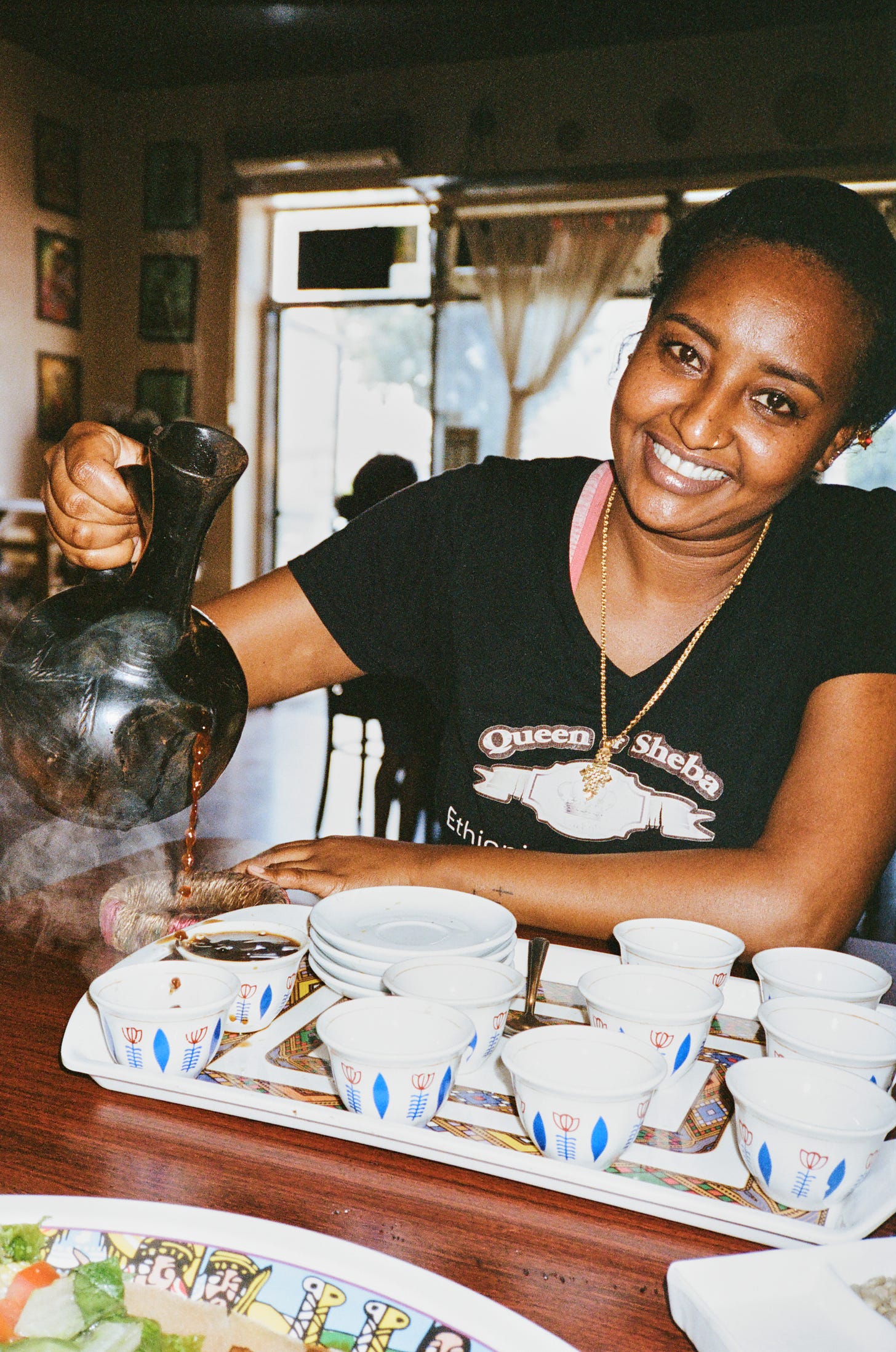 Saba Mengesha pours coffee