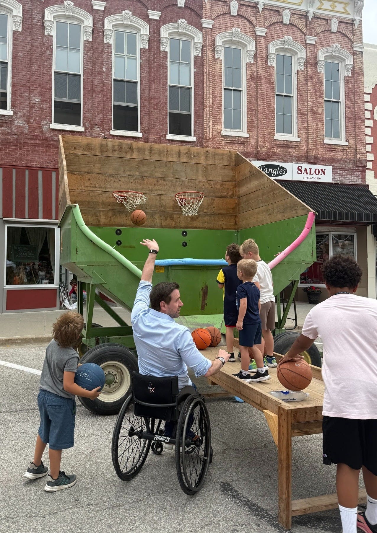 Josh shooting hoops with kids on the campaign trail