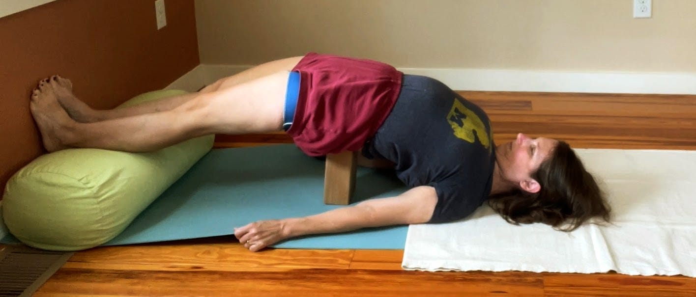 Setu Bandha Sarvangasana with brick and straight legs