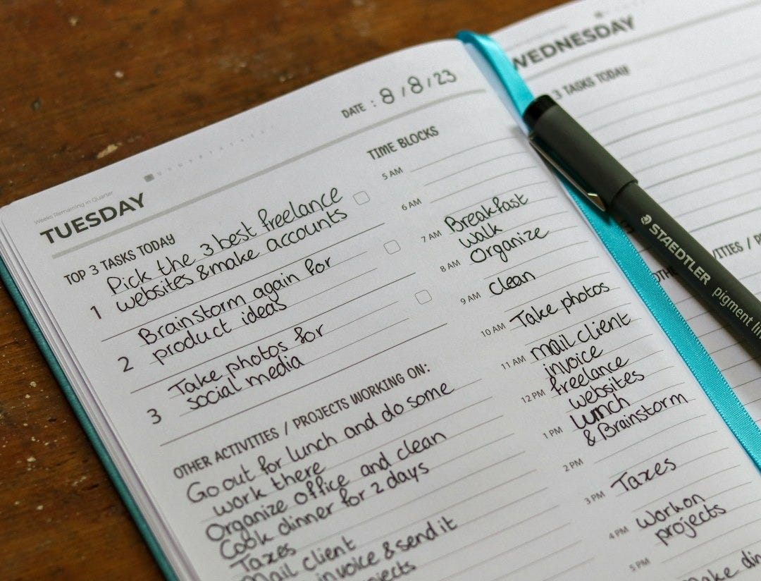 a notebook with a pen on top of it a notebook with a pen on top of it