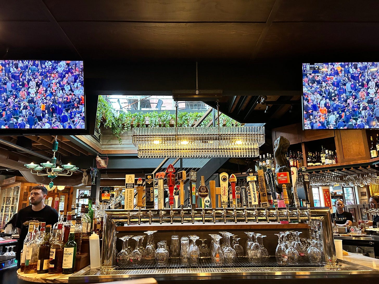 bar, bottles, televisions, people