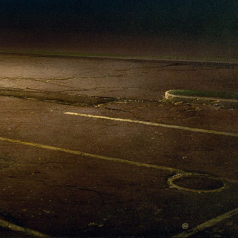 LEFT: Detail from THE ASTROPHYSICIST featuring a narrow grassy island surrounded by blacktop striped yellow for parking spaces. A man lies on his back there shining a spotlight up to the heavens. A swath of trees runs shadowy along the horizon. Above a beautiful night sky of swirling celestial clouds is interrupted only briefly by the stippling of stars. CENTER: Figure detail from THE ASTROPHYSICIST featuring a dark haired, bearded young man lying on his back. He holds a spotlight just over his chest pointed up at the heavens. Jumper cables run from a battery to the spotlight he is pointing straight up into the heavens. RIGHT: Foreground detail from THE ASTROPHYSICIST featuring the weathered blacktop of a desolate parking lot. Yellow stripes mark parking spaces next to a grassy island. One stripe is intersected near the base by the circle of a manhole cover.