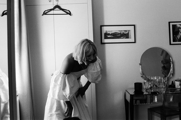 A bride getting dressed before her wedding