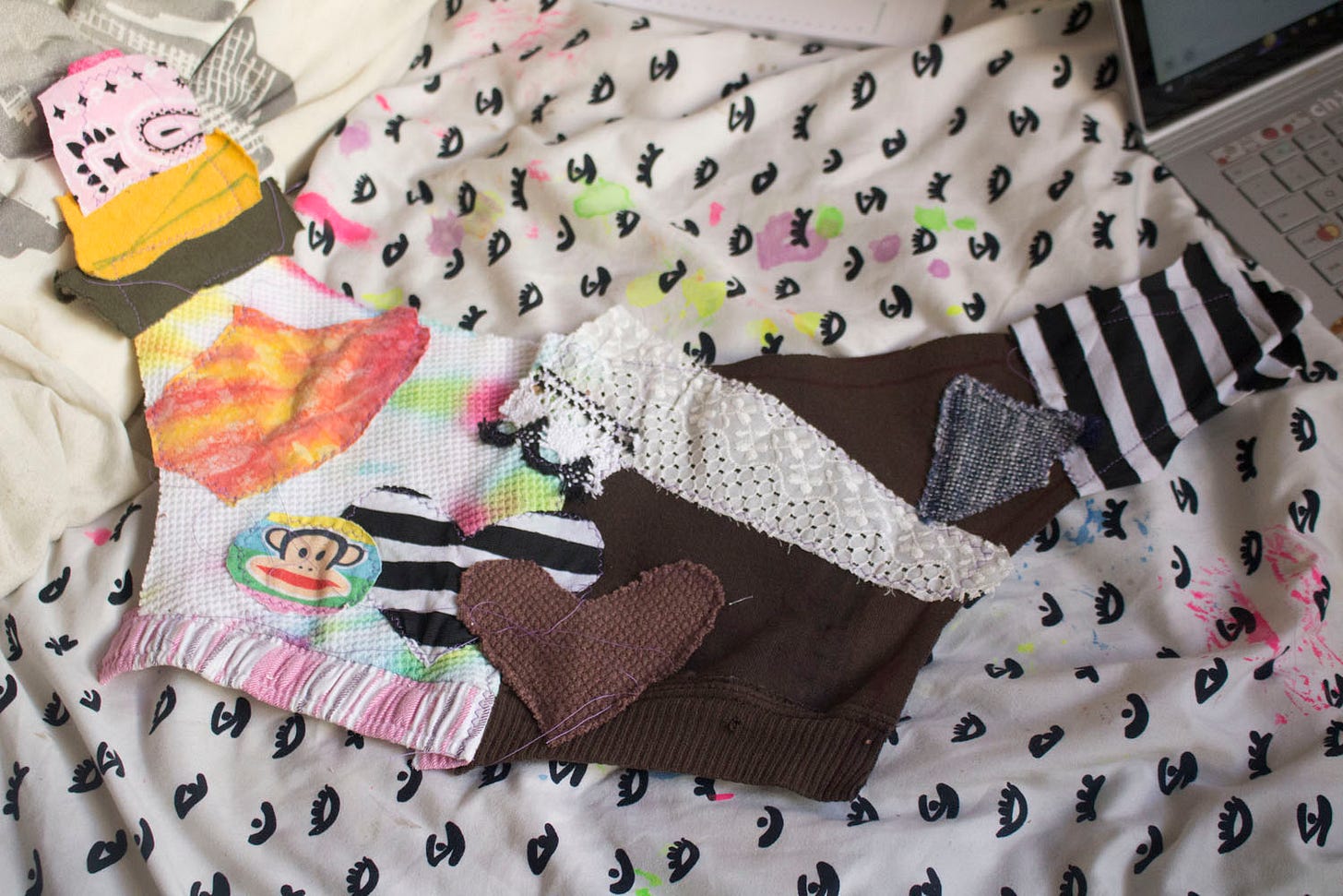 a photo of half of a jester hat, with many different color fabrics sewn onto it