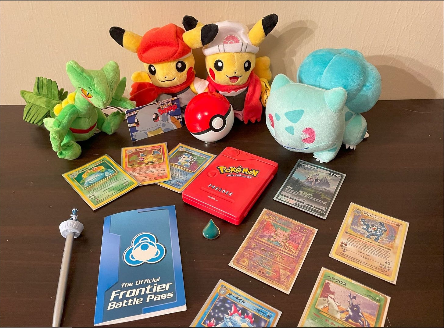 ThunderHero’s collection of Pokémon items, including an electronic Pokédex toy, Pokémon cards featuring some of his favourite creatures, and a Frontier Battle Pass booklet ThunderHero’s collection of Pokémon items, including an electronic Pokédex toy, Pokémon cards featuring some of his favourite creatures, and a Frontier Battle Pass booklet