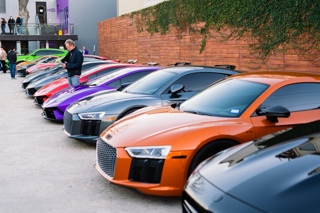 Free A lineup of luxury sports cars parked outdoors during a vibrant car show event. Stock Photo Free A lineup of luxury sports cars parked outdoors during a vibrant car show event. Stock Photo