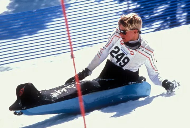 Left: A skier, sitting in an Arroya sit-ski on a ski lift, waves to the camera. Right: A skier races past a slalom gate in an arroya sit ski. The Arroya looks like a cross between a toboggan sled and a whitewater kayak.