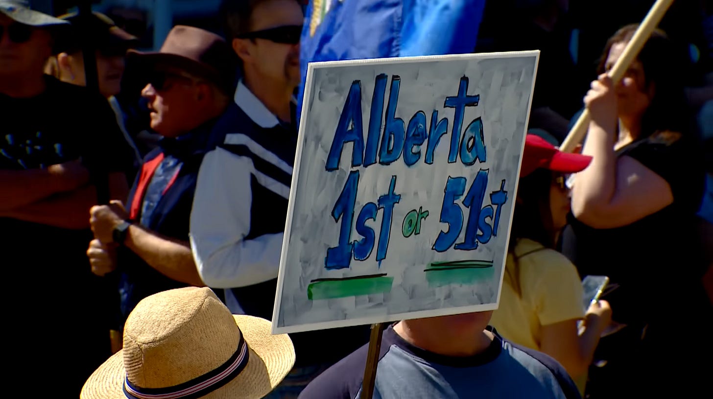A demonstrator holds a sign that says Alberta 1st or 51st
