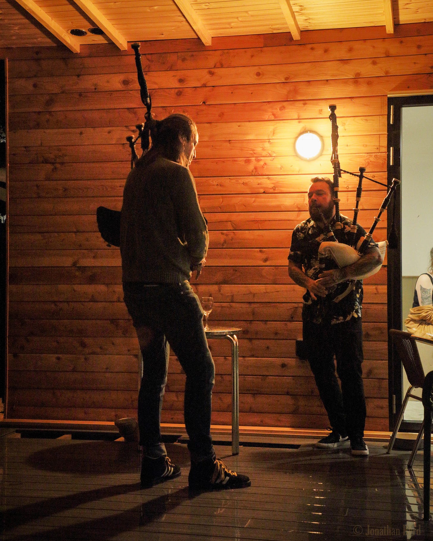 Two men play bagpipes
