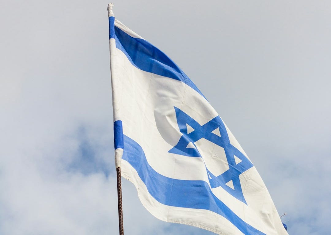 blue and white flag under cloudy sky during daytime blue and white flag under cloudy sky during daytime