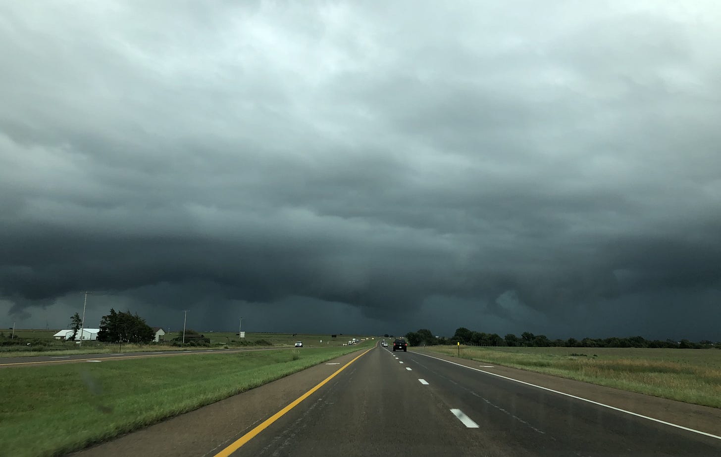 Dark storm clouds loom on the interstate's horizon.
