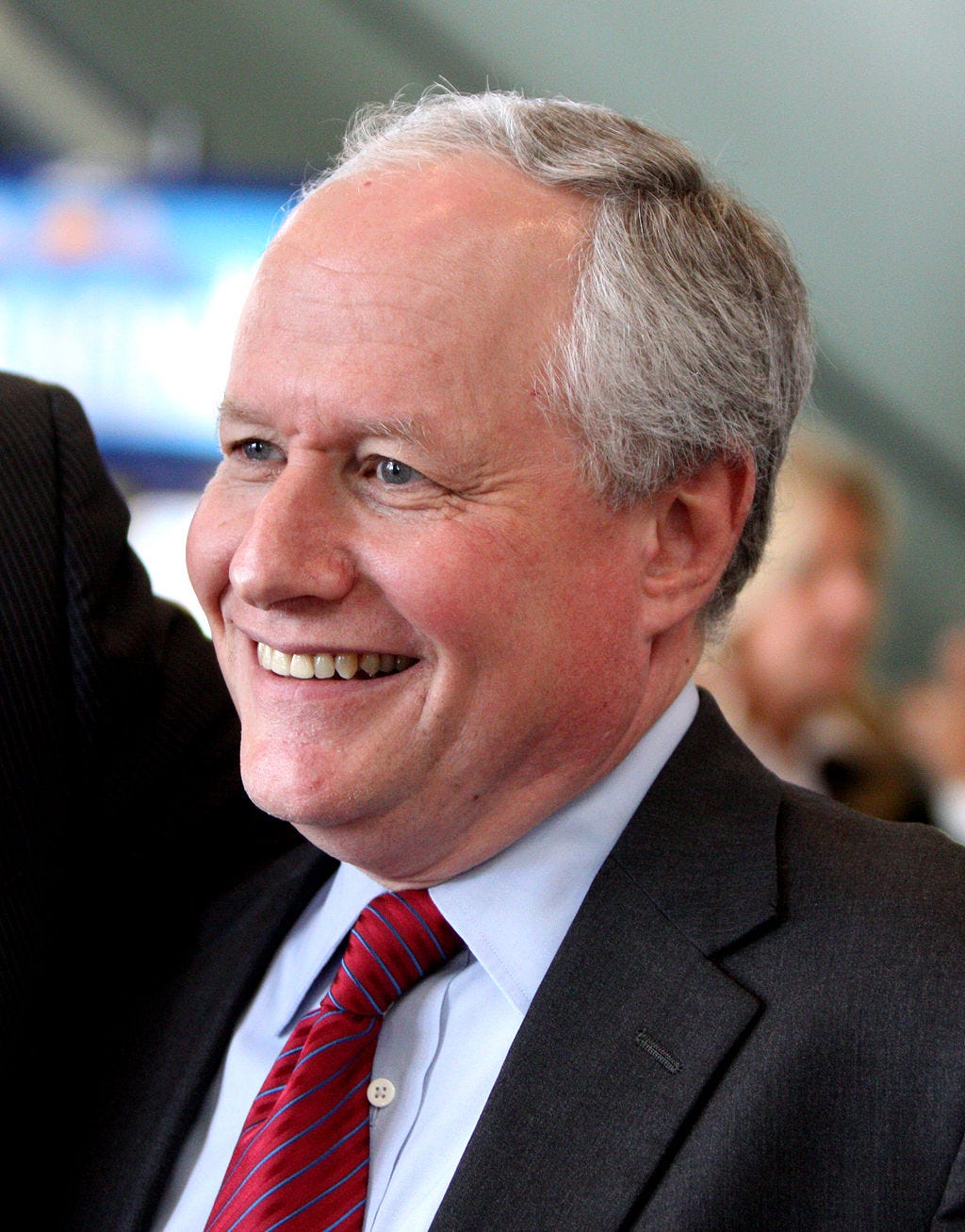 Bill Kristol in 2011 in suit and red striped tie; three quarter headshot, smiling and balding Bill Kristol in 2011 in suit and red striped tie; three quarter headshot, smiling and balding