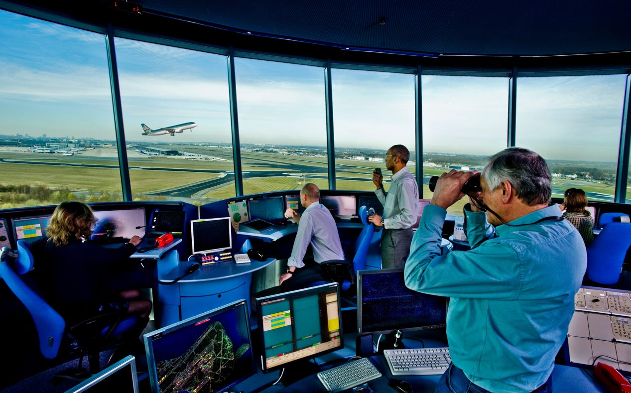 People looking through binoculars at an airplane

Description automatically generated