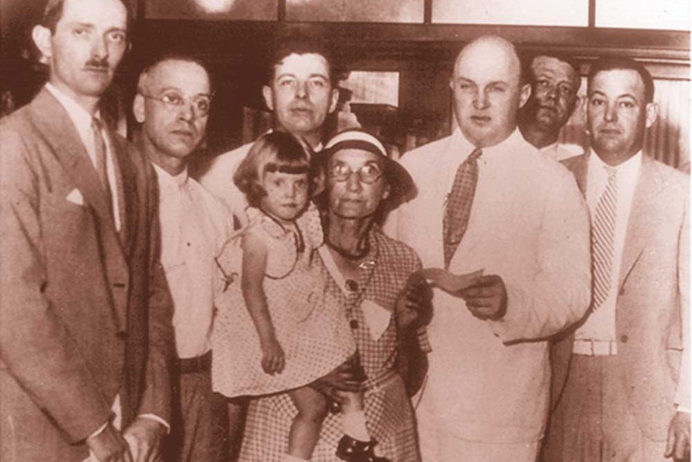 On July 5, 1934, Mrs. Lydia Lobsiger received the first federal deposit insurance disbursement, following the failure of the Fond Du Lac State Bank in East Peoria, Illinois. Photo: UPI 