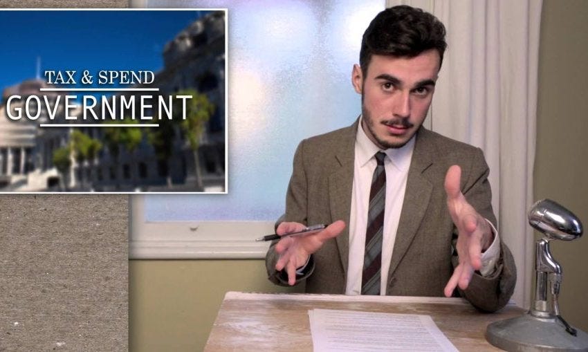 A white man sat behind a desk A white man sat behind a desk