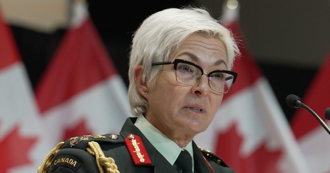 The Chief of the Defence Staff, General Jennie Carignan, in uniform, addressing behind a podium equipped with microphones.