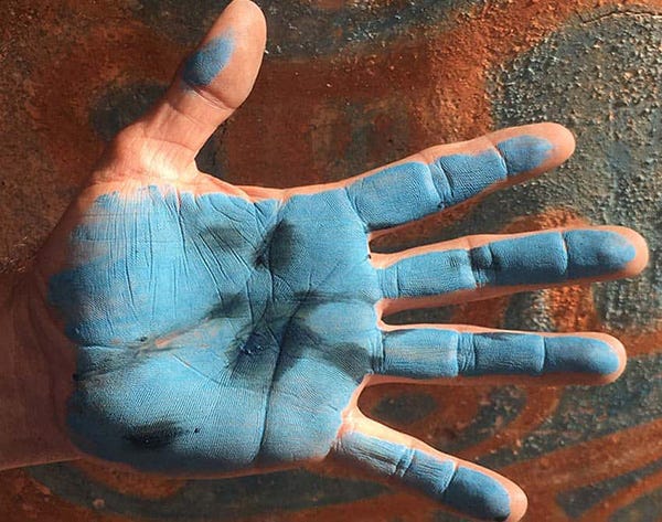 hand with Mayan blue paint, photo by Mark Viales