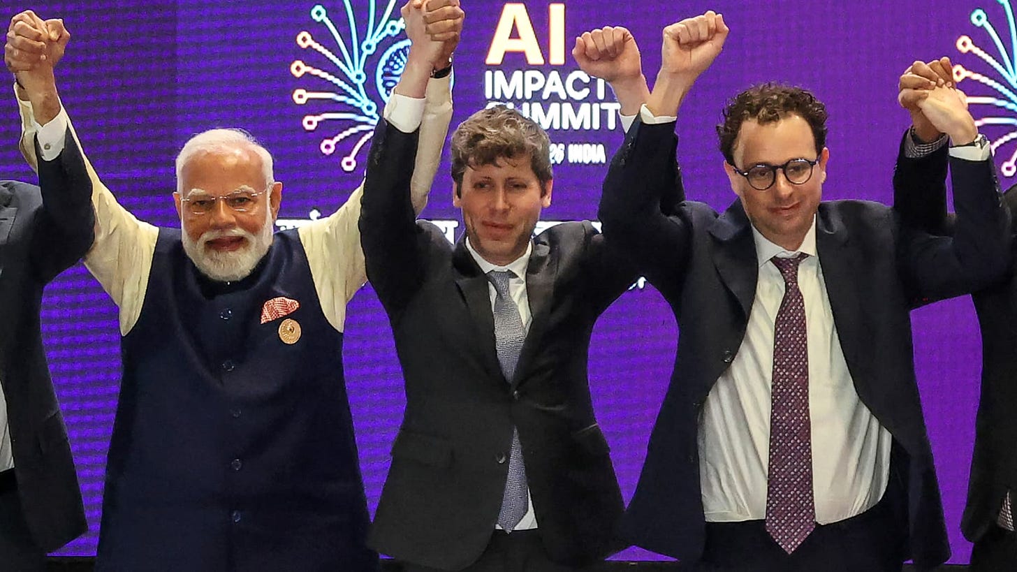 India's Prime Minister Narendra Modi (L) takes a group photo with AI company leaders including OpenAI CEO Sam Altman (C) and Anthropic CEO Dario Amodei (R) at the AI Impact Summit in New Delhi on February 19, 2026.  (Photo by Ludovic MARIN / AFP via Getty Images)