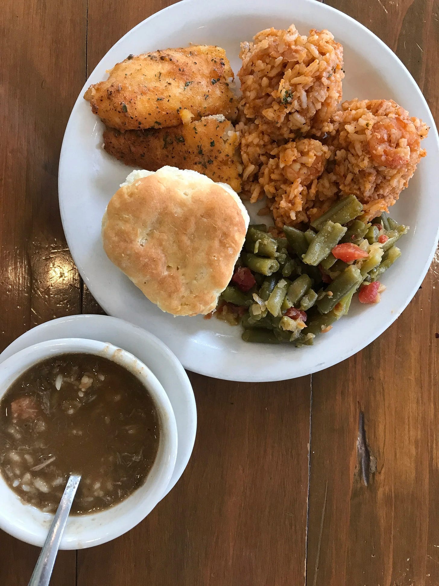  Traditional Cajun and Creole food of Gumbo, Jambalaya, Green Beans, Fried Catfish, and biscuit from La Cuisine de Maman, a restaurant onsite of Vermilionville in Lafayette, LA.  